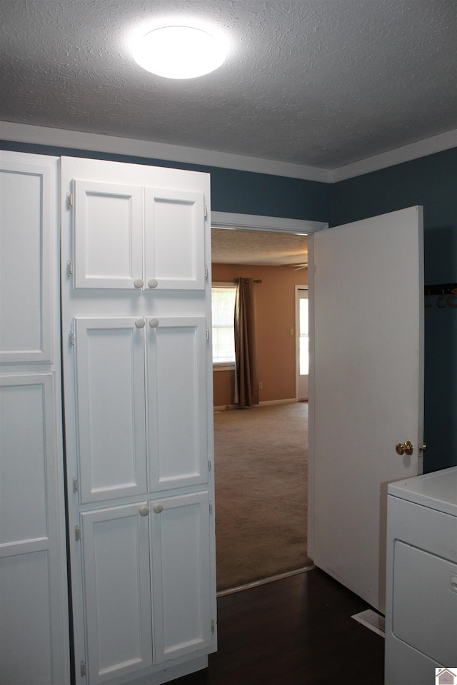 1725 Evelyn Dr, Paducah, KY 42003 - hall with a textured ceiling, dark colored carpet, dark wood-type flooring, and washer / clothes dryer