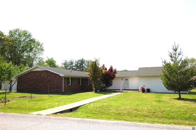 ranch-style home with a front lawn and brick siding