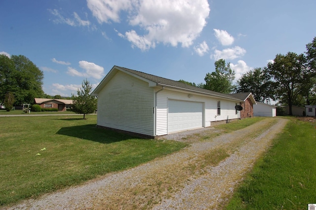 view of side of home featuring a yard and driveway