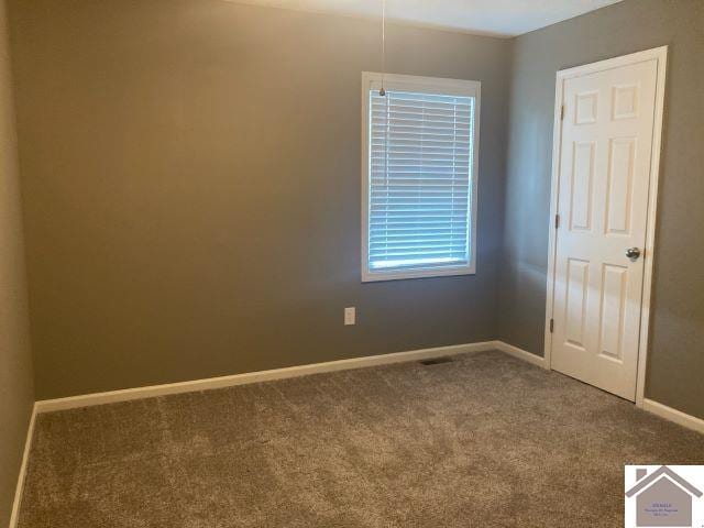 carpeted empty room with baseboards