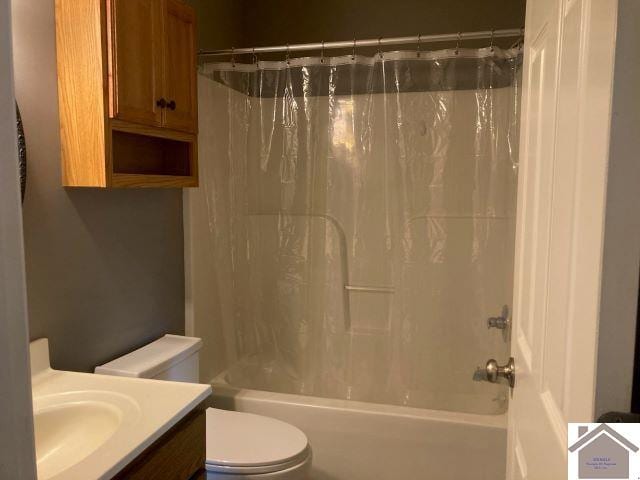 bathroom featuring toilet, shower / tub combo with curtain, and vanity