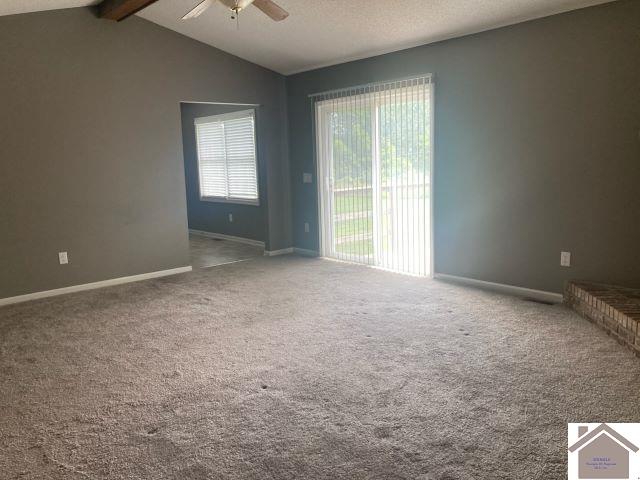 carpeted empty room with ceiling fan and baseboards