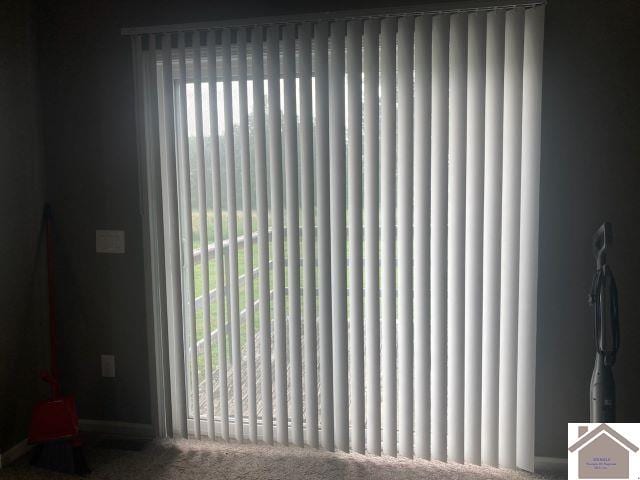detailed view of a gate, radiator, and baseboards