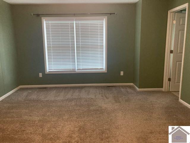 empty room with carpet flooring and baseboards