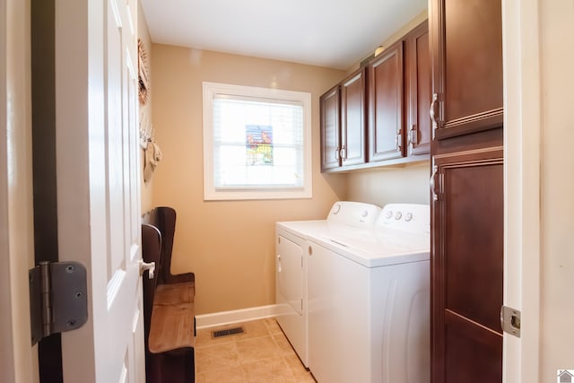 laundry area featuring cabinet space, washing machine and clothes dryer, baseboards, light tile patterned floors, and visible vents
