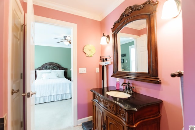 ensuite bathroom featuring vanity, ornamental molding, a ceiling fan, and ensuite bath