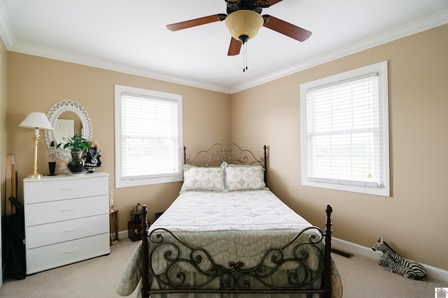 bedroom with crown molding, baseboards, and light carpet