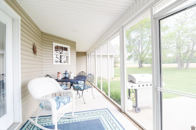 sunroom / solarium with outdoor dining area