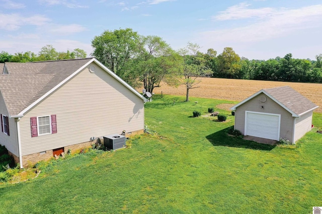 view of yard with cooling unit, an outdoor structure, and a garage