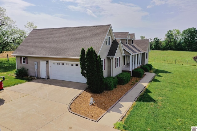 view of side of home featuring a lawn, a garage, roof with shingles, and driveway