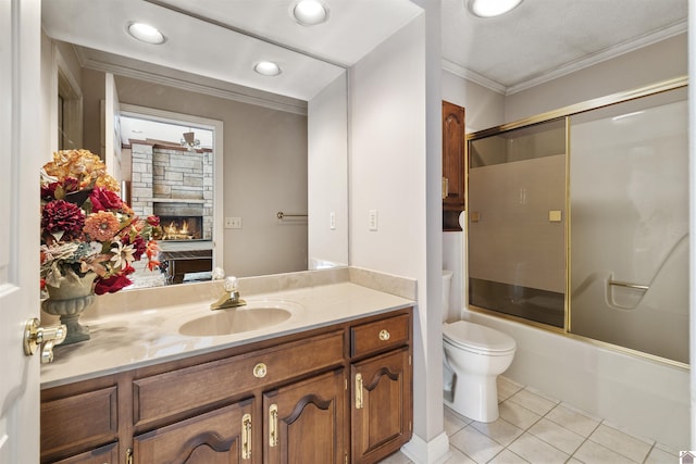 bathroom featuring crown molding, tile patterned flooring, vanity, toilet, and shower / bath combination with glass door