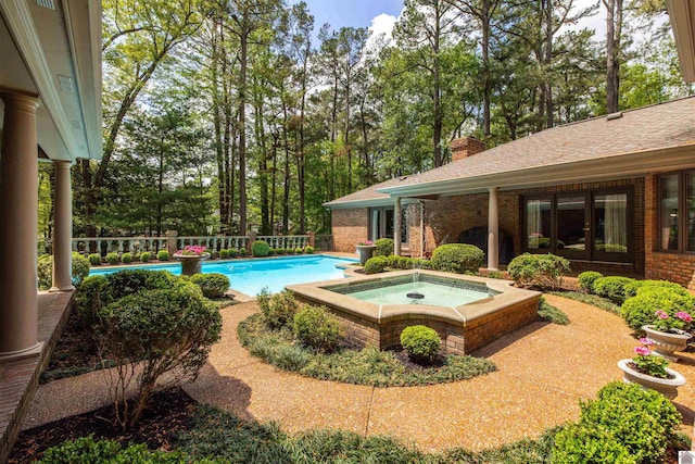 view of pool with an in ground hot tub and a fenced in pool