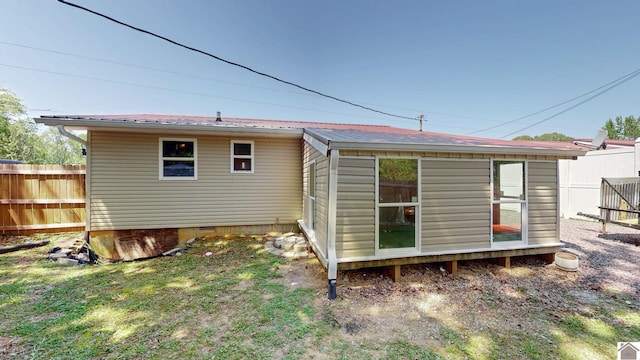 back of house with fence and crawl space