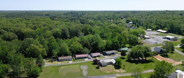 birds eye view of property with a wooded view