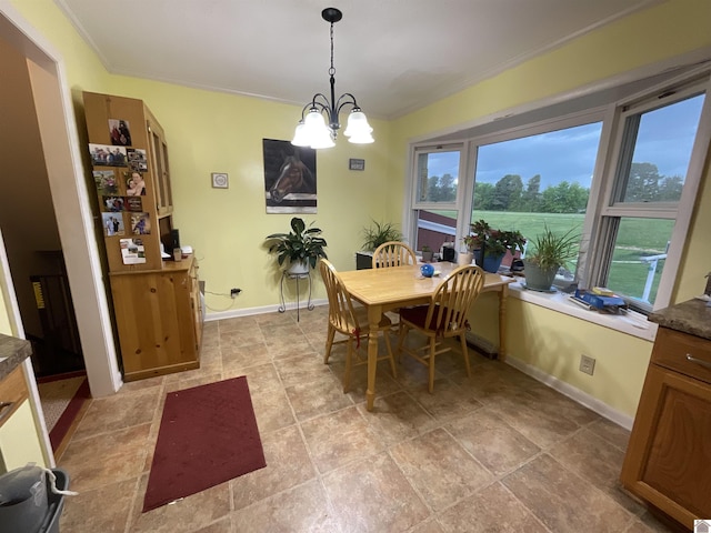 dining area featuring crown molding, a chandelier, and a healthy amount of sunlight