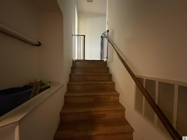 stairway featuring wood finished floors