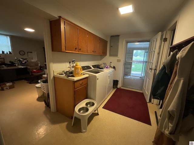 clothes washing area featuring laundry area, washer and clothes dryer, plenty of natural light, and electric panel
