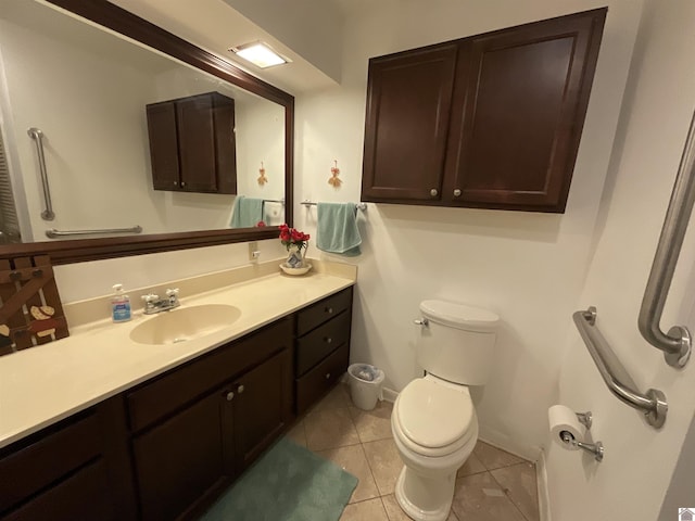 bathroom featuring toilet, baseboards, tile patterned flooring, and vanity