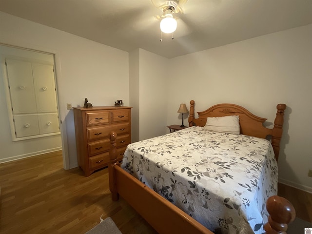 bedroom with baseboards, a ceiling fan, and wood finished floors