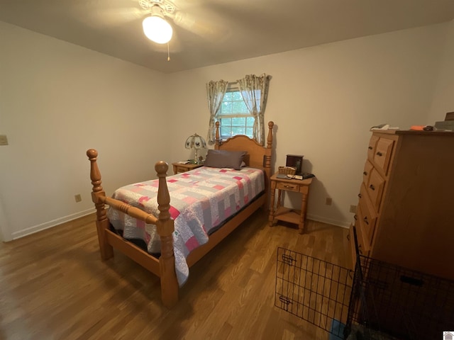 bedroom featuring baseboards and wood finished floors