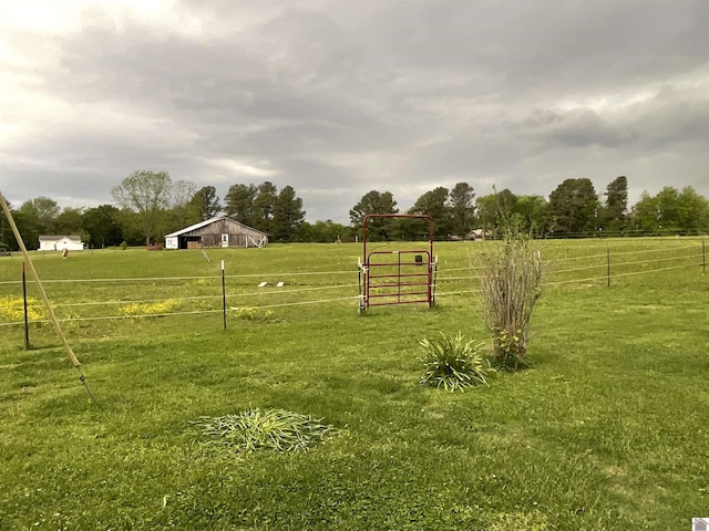 view of yard featuring a rural view and fence