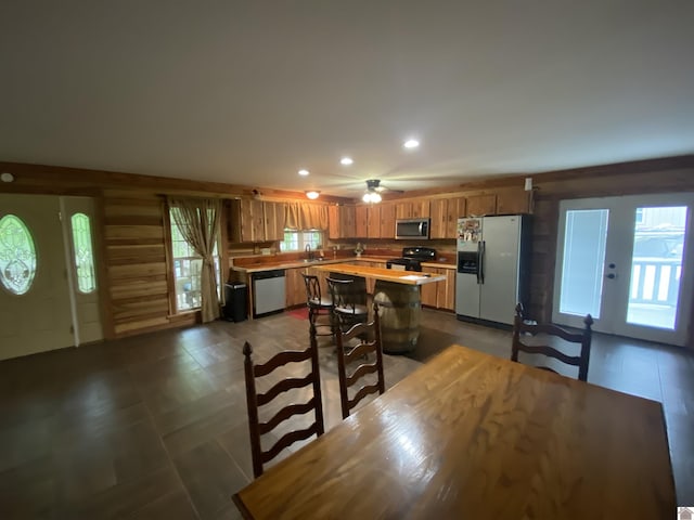 kitchen with brown cabinets, a sink, light countertops, stainless steel appliances, and recessed lighting