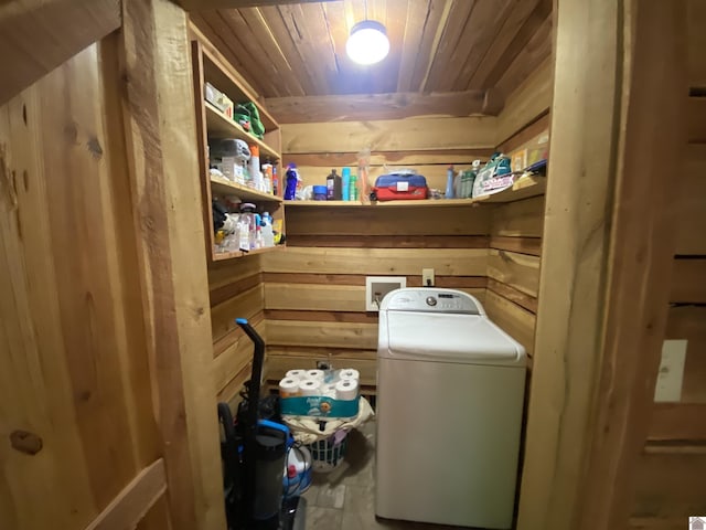 washroom featuring wooden walls, wood ceiling, and washer / clothes dryer