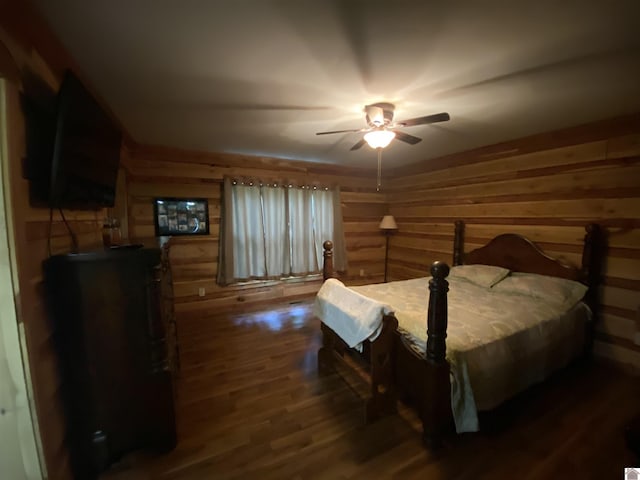 bedroom featuring wood walls and dark wood-type flooring