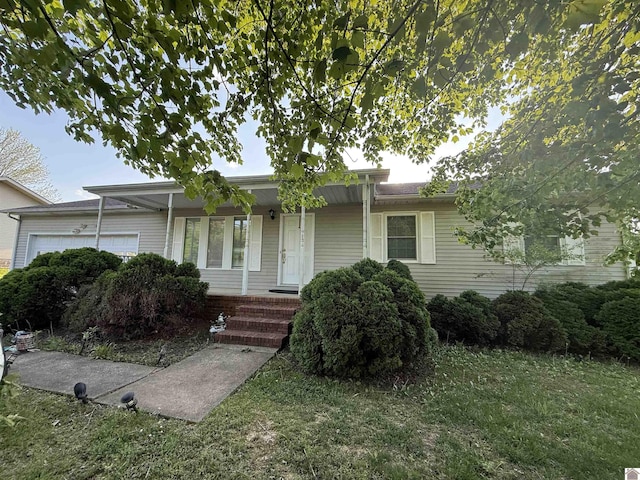 ranch-style house featuring a garage, a porch, and a front yard