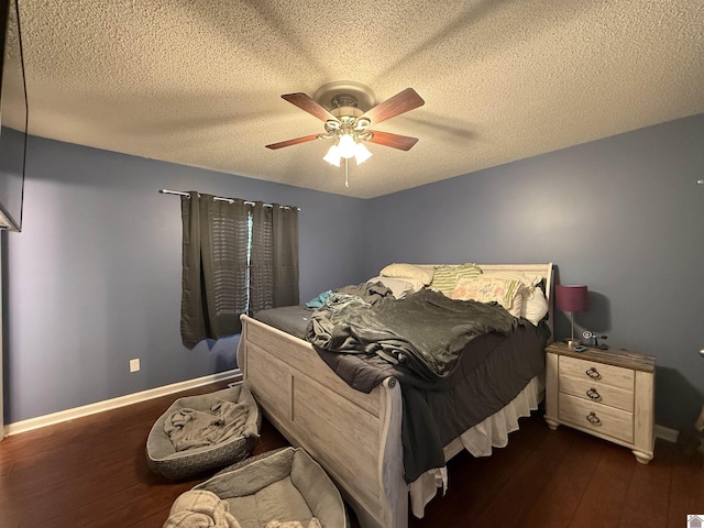 bedroom with baseboards, a textured ceiling, dark wood finished floors, and ceiling fan
