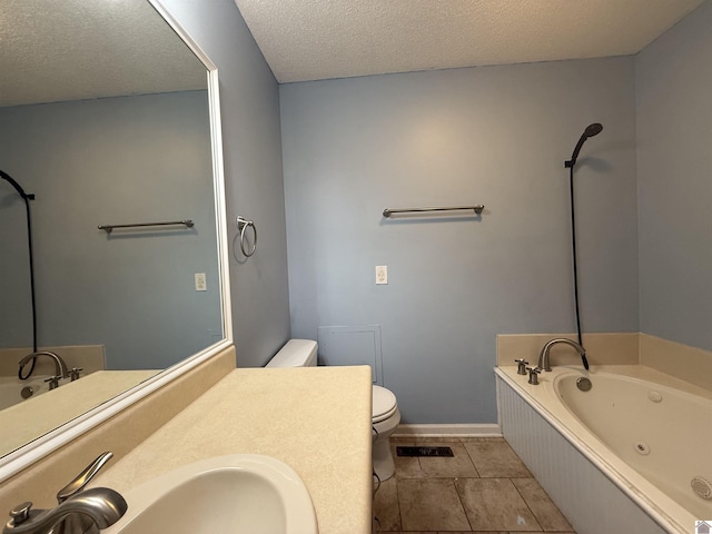 bathroom with tile patterned floors, toilet, a tub with jets, and a textured ceiling