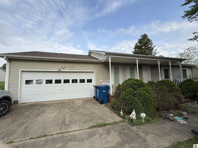 view of front of property with concrete driveway and a garage