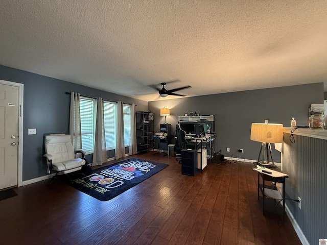 office space featuring baseboards, a ceiling fan, a textured ceiling, and wood finished floors