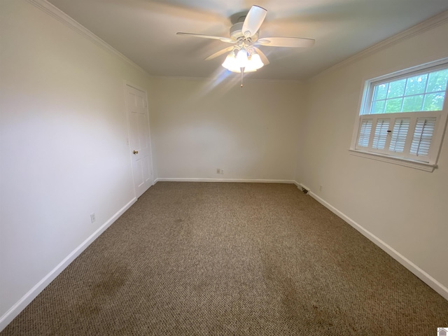 carpeted empty room featuring ceiling fan, ornamental molding, and baseboards