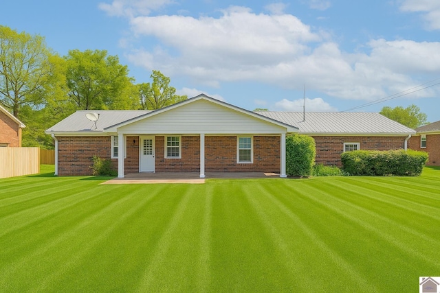 39 Gibbs Store Rd, Murray, KY 42071 - back of property featuring a lawn, fence, and brick siding
