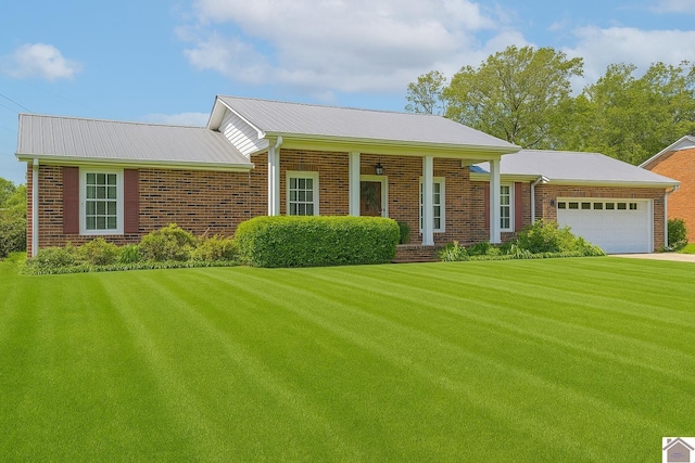 39 Gibbs Store Rd, Murray, KY 42071 - view of front facade with brick siding, a garage, a front lawn, and concrete driveway