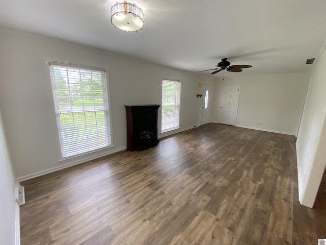 unfurnished living room with visible vents, wood finished floors, a fireplace, baseboards, and ceiling fan