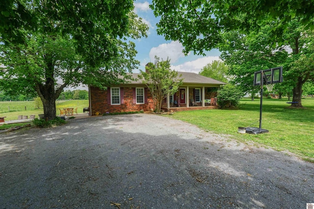 ranch-style home with a porch and a front lawn