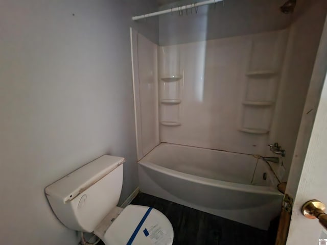 bathroom with shower / tub combination, wood finished floors, and toilet