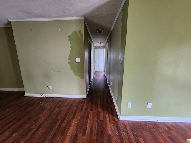 hall with baseboards, ornamental molding, and wood finished floors