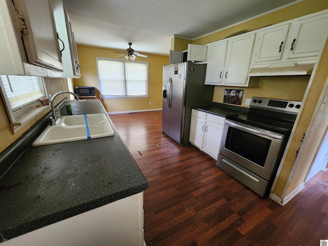 kitchen featuring a sink, dark countertops, stainless steel appliances, and dark wood-type flooring