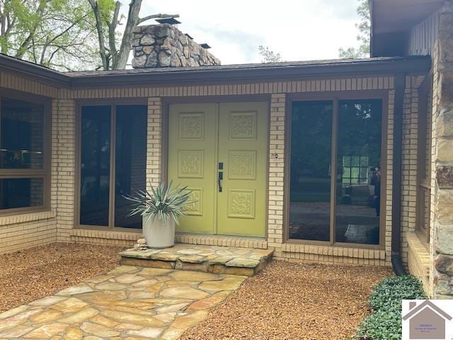property entrance with brick siding