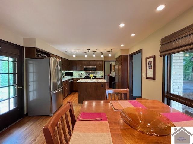 dining area featuring recessed lighting and light wood-style flooring