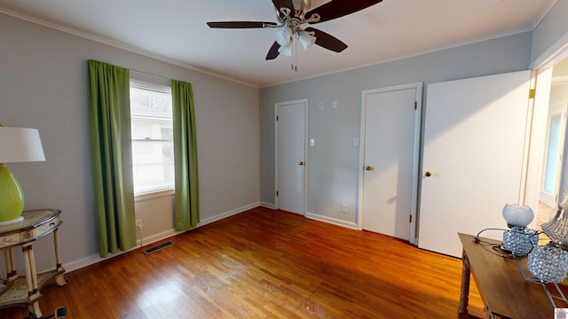 608 E 12th St, Benton, KY 42025 - unfurnished bedroom with ceiling fan, visible vents, baseboards, light wood-style floors, and ornamental molding