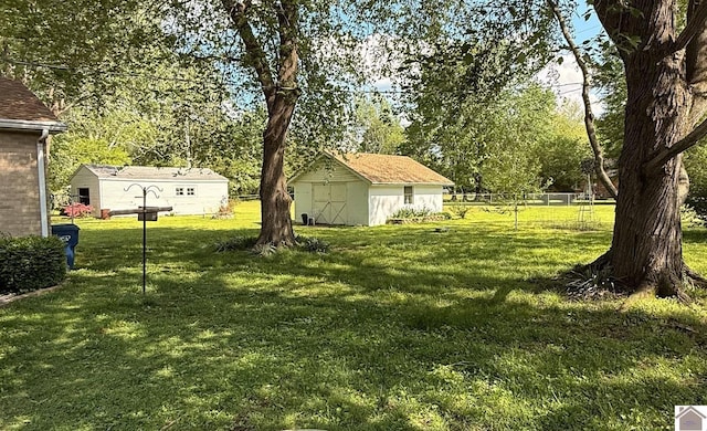 608 E 12th St, Benton, KY 42025 - view of yard with a shed, an outbuilding, and fence