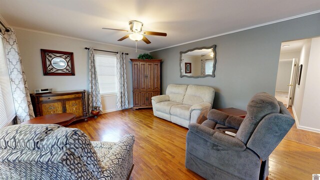 608 E 12th St, Benton, KY 42025 - living room featuring a ceiling fan, baseboards, ornamental molding, and light wood finished floors