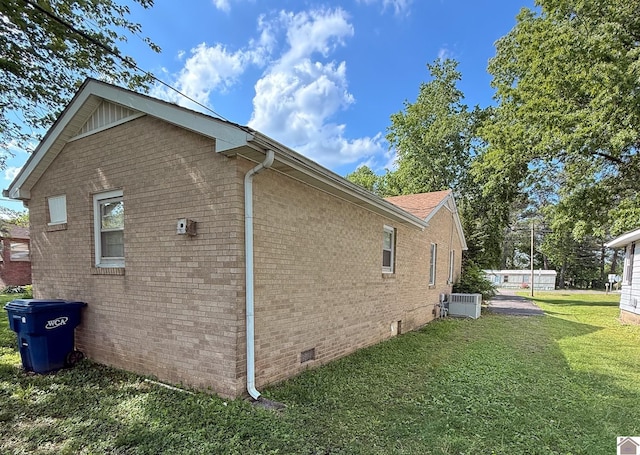 608 E 12th St, Benton, KY 42025 - view of home's exterior with central AC unit, a yard, crawl space, and brick siding