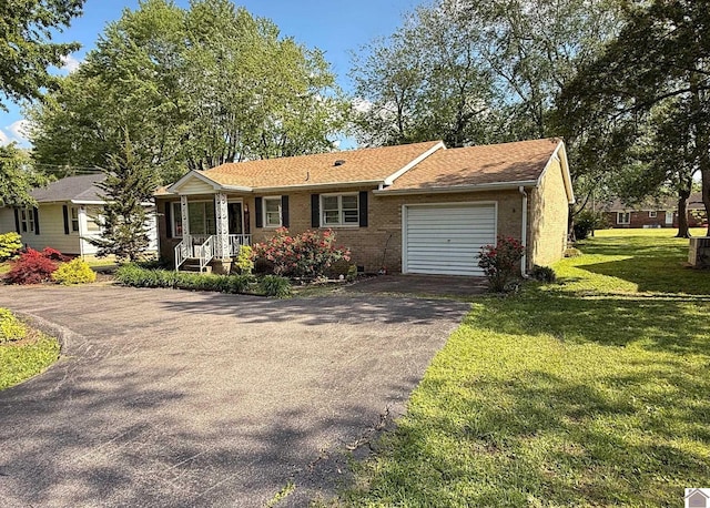 608 E 12th St, Benton, KY 42025 - ranch-style home with covered porch, aphalt driveway, brick siding, a front lawn, and an attached garage