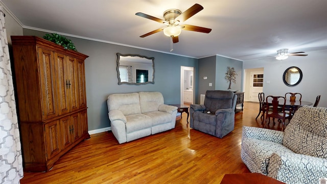 608 E 12th St, Benton, KY 42025 - living room with light wood-style floors, baseboards, ornamental molding, and a ceiling fan