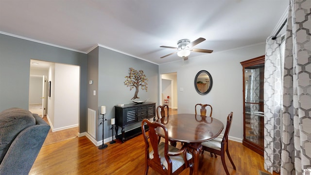 608 E 12th St, Benton, KY 42025 - dining space featuring baseboards, ceiling fan, crown molding, and wood finished floors